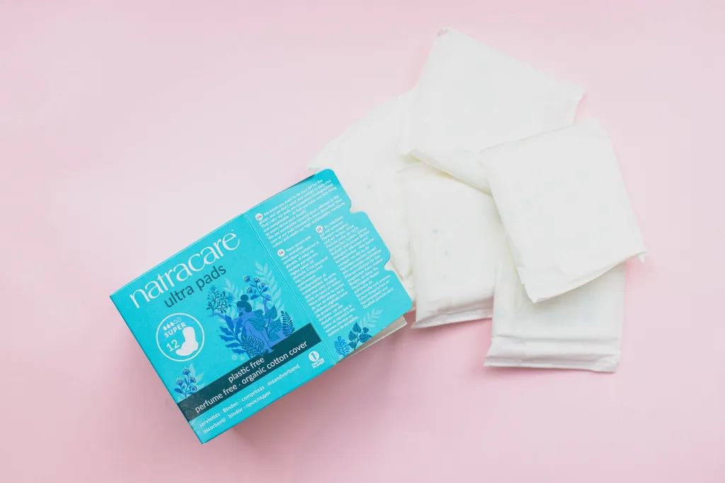 A box of sanitary pads with some open pads next to the box